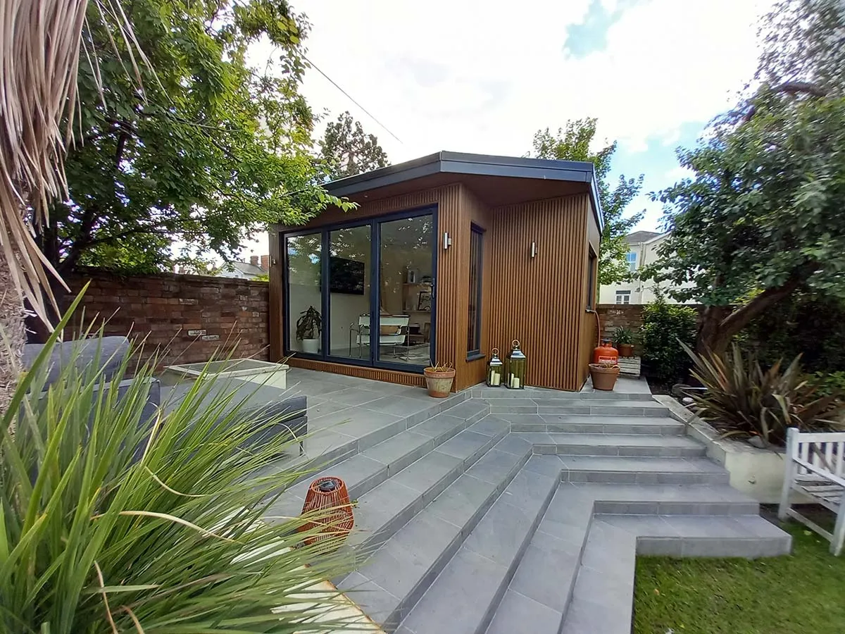 beautiful corner garden room cladd with teak composite wood